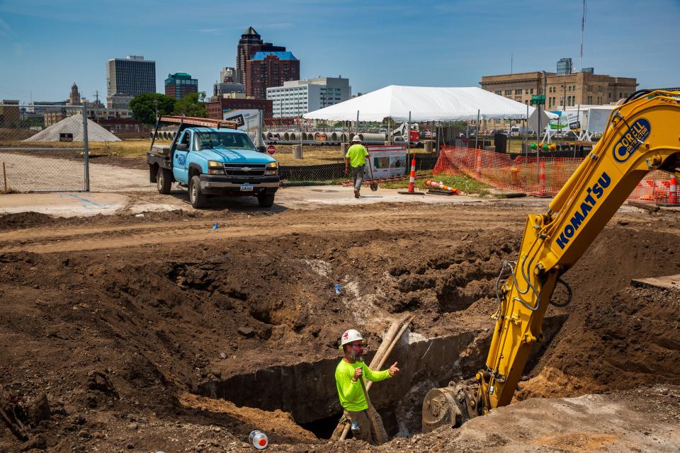 Workers with Corell Contractors dig near Southeast Third and Market streets, part of the new Market District south of the East Village