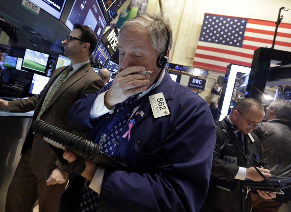 Trader Warren Meyers, center, works on the floor of the New York Stock Exchange Tuesday, Jan. 28, 2014. Stocks are higher in early trading on Wall Street as the stock market turns positive after three days of losses. (AP Photo/Richard Drew)