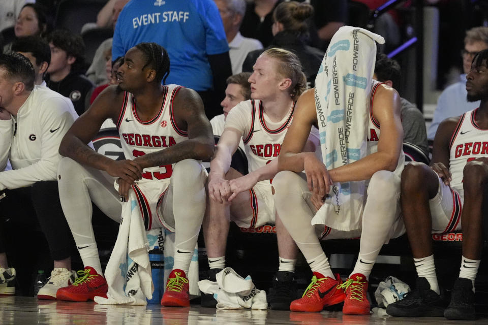 Georgia players from left; Jalen DeLoach (23), Blue Cain (0) and Jabri Abdur-Rahim (1) sit on the bench in the final moments of thier loss to Alabama in an NCAA college basketball game Wednesday, Jan. 31, 2024, in Athens, Ga. (AP Photo/John Bazemore)
