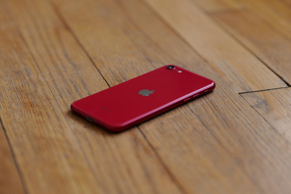 Apple iPhone SE (2020) on hardwood floor.