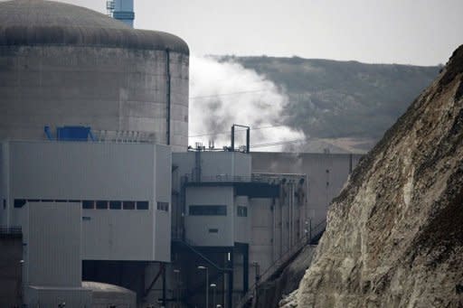 White smoke appearing at the Penly nuclear power plant, in Penly, France. Radioactive cooling fluid leaked at a French nuclear reactor Thursday following two small fires, but the spillage was safely collected in special tanks, officials said