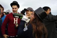 Harvard and Yale University football fans drink champagne outside the stadium before their football game against Yale University at Harvard in Cambridge, Massachusetts November 22, 2014. Known as "The Game," the first Harvard versus Yale football game was played in 1875, making it one of the oldest rivalries in college sports. REUTERS/Brian Snyder (UNITED STATES - Tags: EDUCATION SPORT SOCIETY FOOTBALL)