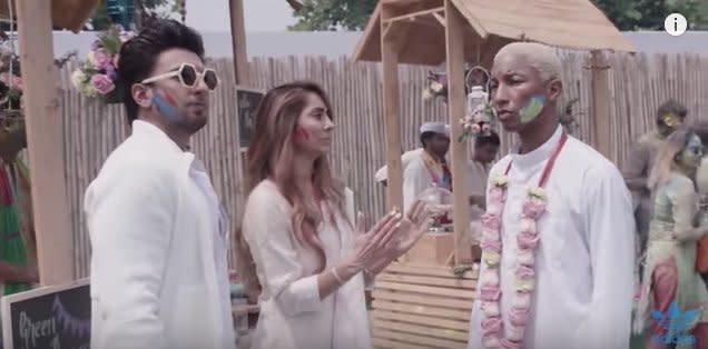 Pharrell Williams listens as Bollywood star&nbsp;Ranveer Singh and presenter&nbsp;Anusha Dandekar explain Holi, a Hindu spring festival. (Photo: adidas Originals/YouTube)