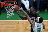 Boston Celtics guard Derrick White (9) pressures Miami Heat forward Jimmy Butler (22) on a shot during the first half of Game 4 of the NBA basketball playoffs Eastern Conference finals, Monday, May 23, 2022, in Boston. (AP Photo/Charles Krupa)