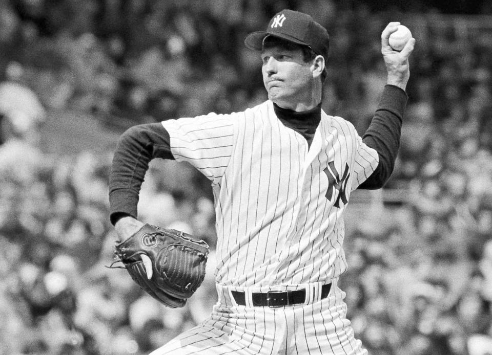 THS DELETES ANY REFERENCE TO TOMMY JOHN BEING A COVID DENIER - FILE - In this 1979 file photo, New York Yankees pitcher Tommy John delivers during a baseball game. Tommy John has been battling COVID-19 for at least three weeks. The 77-year-old former pitching great remains hospitalized near his home in Indio, California. He said he started to feel ill following a trip to Nashville before he was hospitalized on Dec. 13. (AP Photo/File)
