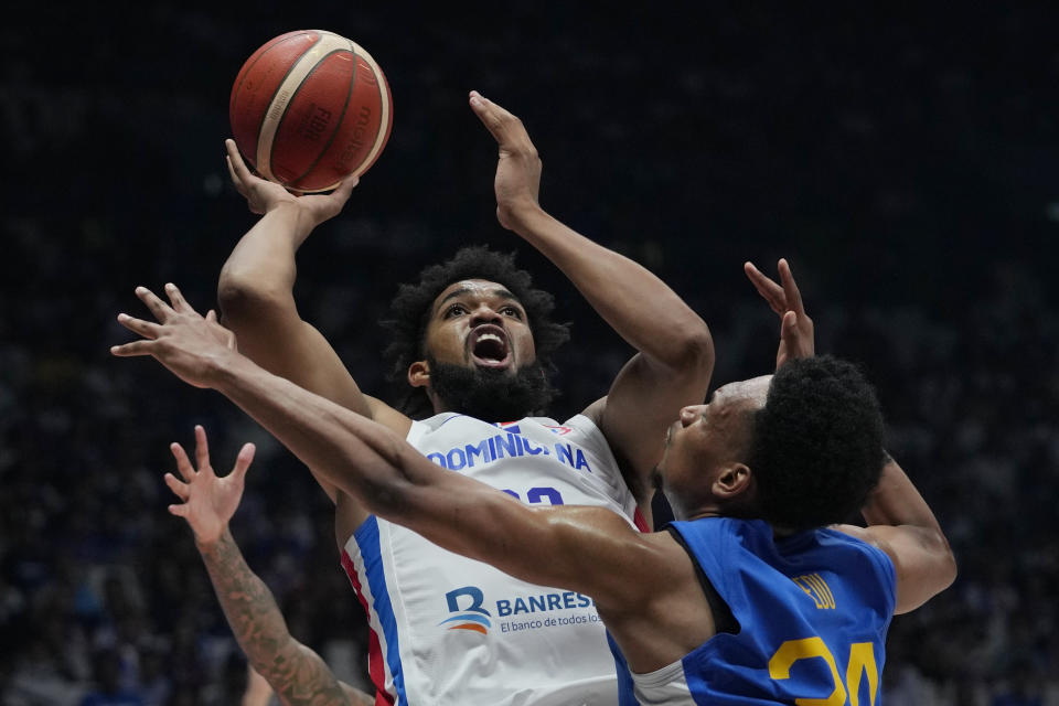 Dominican Republic forward Karl-Anthony Towns (32) shoots against Philippines center Ariel John Edu (34) during the Basketball World Cup at the Philippine Arena in Bulacan province, Philippines Friday, Aug. 25, 2023. (AP Photo/Aaron Favila)