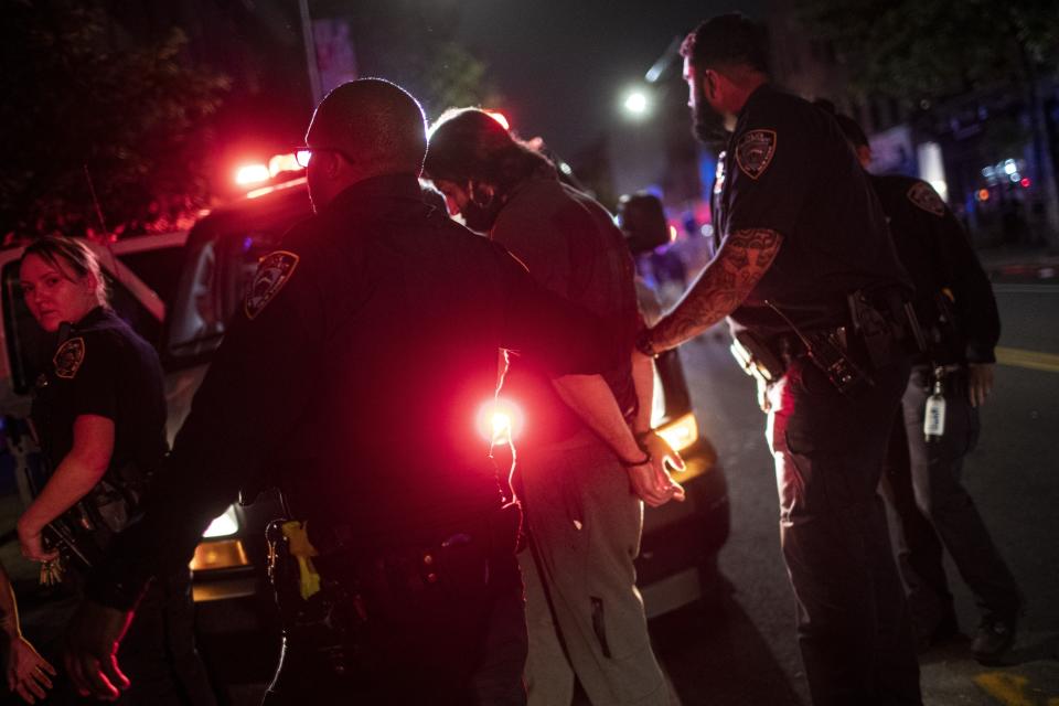 A protester is arrested near Barclays Center after a rally over the death of George Floyd, a black man who was in police custody in Minneapolis, on Friday, May 29, 2020, in the Brooklyn borough of New York. Floyd died after being restrained by Minneapolis police officers on Memorial Day. (AP Photo/Wong Maye-E)