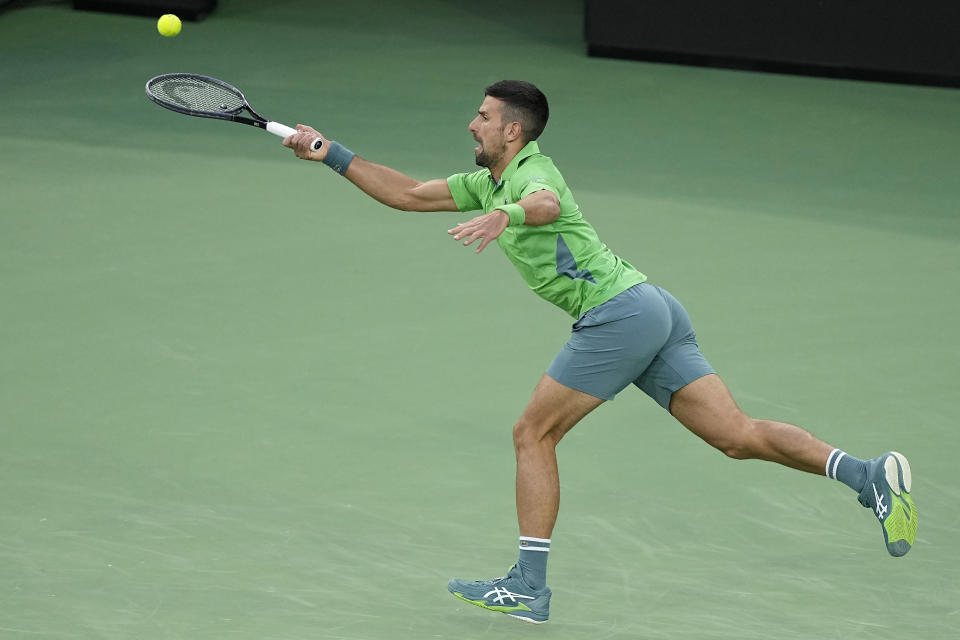 Novak Djokovic, of Serbia, returns a shot against Luca Nardi, of Italy, at the BNP Paribas Open tennis tournament, Monday, March 11, 2024, in Indian Wells, Calif. (AP Photo/Mark J. Terrill)