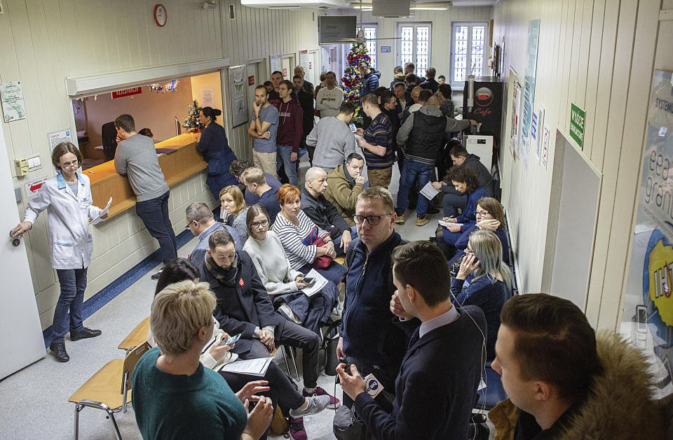 People line up to donate blood for Gdansk Mayor Adamowicz, who is in critical condition and needs blood transfusions after being stabbed in the heart and abdomen on stage during a charity event the evening before, in Gdansk, Poland, Monday Jan. 14, 2019. Doctors operated for five hours on Adamowicz after an ex-convict rushed onto the stage with a knife, carried out the attack and shouted it was political revenge against a political party Adamowicz previously belonged to. (Krzysztof Mystkowski / KFP via AP) POLAND AUT