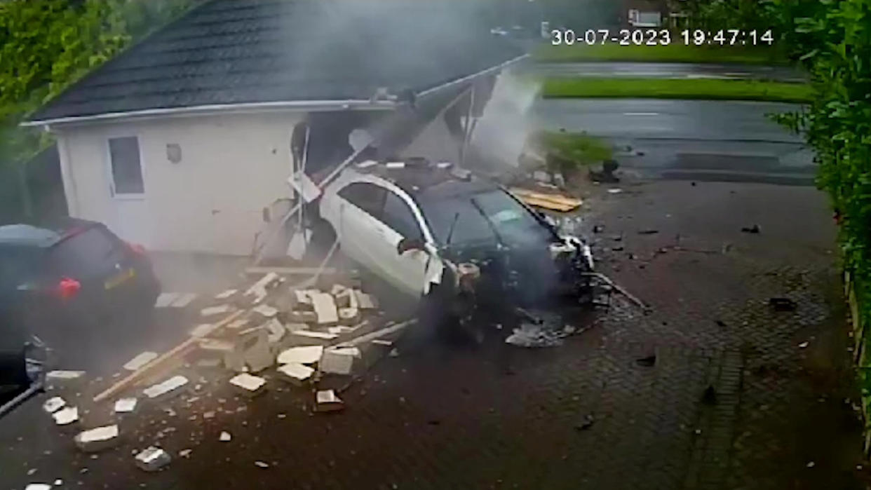Video grab of the moment a Mercedes-Benz 'driven by a teen' smashed into a garage - causing 