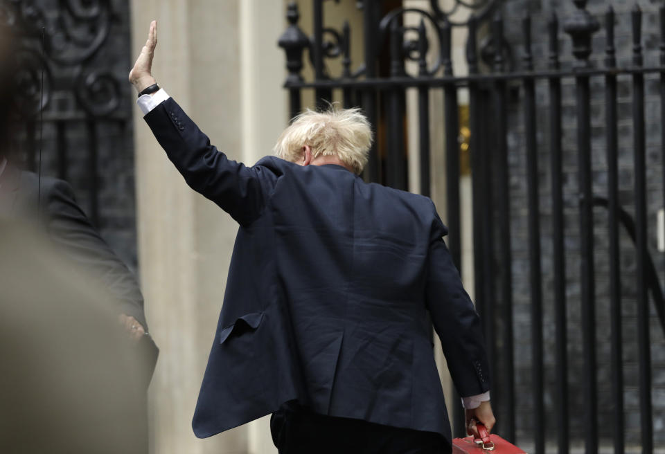 British Prime Minister Boris Johnson waves as he arrives at Downing Street in London, Wednesday, Sept. 25, 2019. Lawmakers in Britain are returning to the House of Commons on Wednesday, following a Supreme Court ruling that Prime Minister Boris Johnson had acted illegally by suspending Parliament. (AP Photo/Matt Dunham)