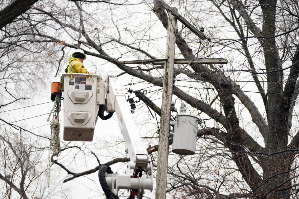 A DTE contractor crew works on a power line, Monday, Feb. 27, 2023, in northwest Detroit. Some Michigan residents faced a fourth straight day without power as crews worked to restore electricity to more than 165,000 homes and businesses in the Detroit area after last week's ice storm. (AP Photo/Carlos Osorio)