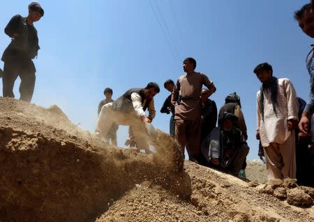 Relatives take part in a burial ceremony of the victims of yesterday's suicide attack in Kabul, Afghanistan July 25, 2017.REUTERS/Mohammad Ismail