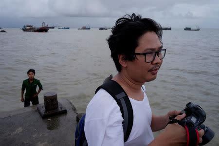 FILE PHOTO: Reuters journalist Wa Lone, who is based in Myanmar, is seen working in Sittwe in the state of Rakhine, Myanmar September 18, 2017. REUTERS/Andrew Marshall/File Photo