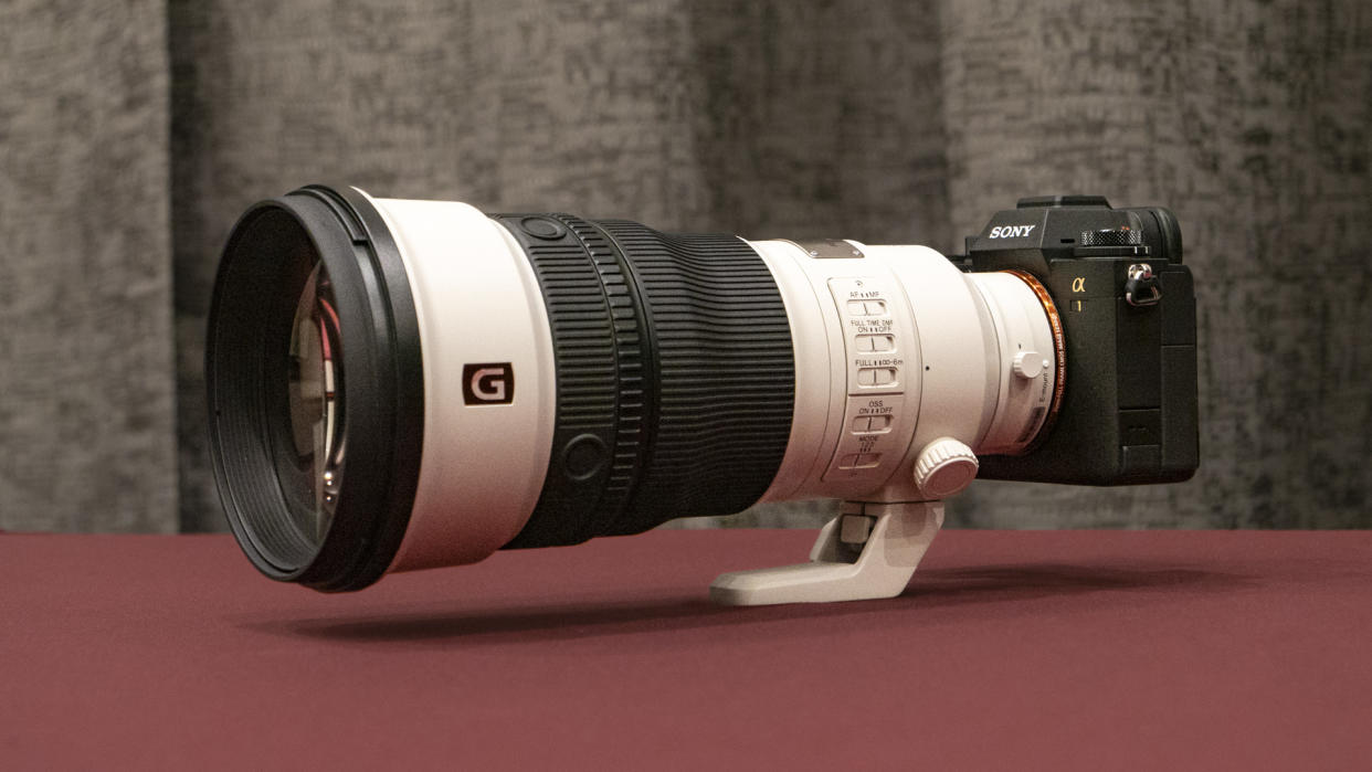  Sony FE 300mm F2.8 GM OSS lens on a red table . 