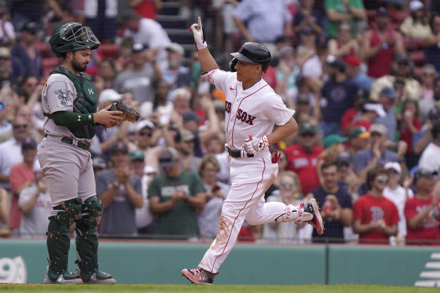 Masataka Yoshida of the Boston Red Sox celebrates in the dugout