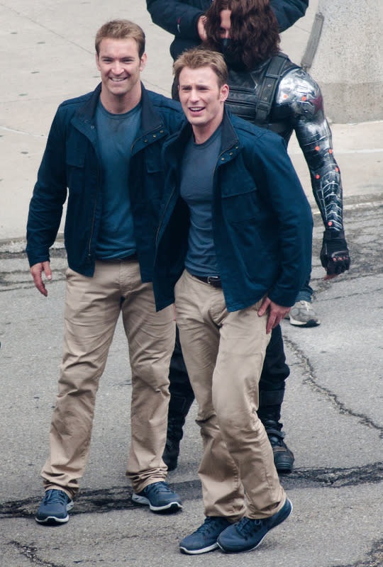 <p>Same outfit. But not the same superhero. Evans (right) hangs out with his stunt double, Sam Hargrave, (and Sebastian Stan, a.k.a. Bucky Barns a.k.a. the Winter Solider, in the background) on the set of <i>Captain America: The Winter Soldier</i> while filming in Cleveland. <br></p><p><i>(Photo: Splash News)</i></p>