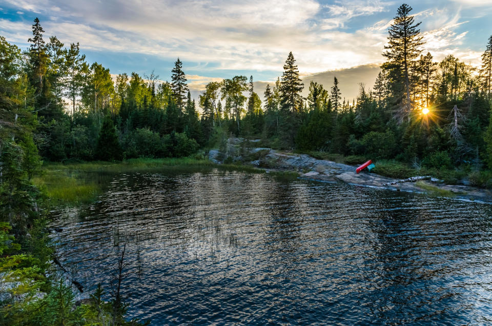 A textured lake surface foregrounds a view of Isle Royale.