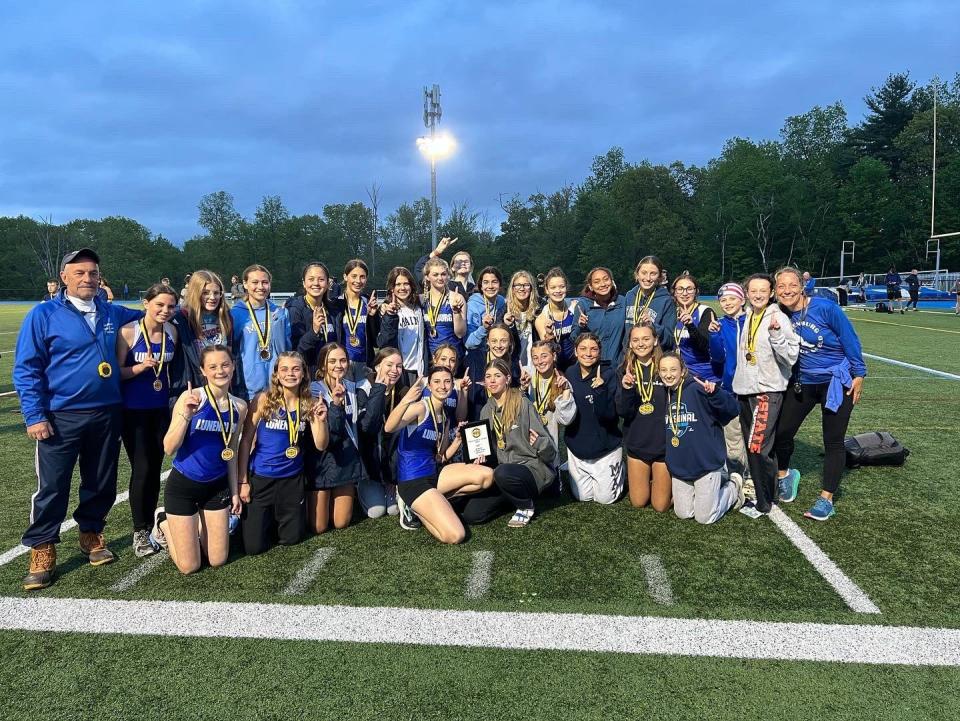 The Lunenburg girls' track team celebrates its win in the Mid-Wach C Championships.