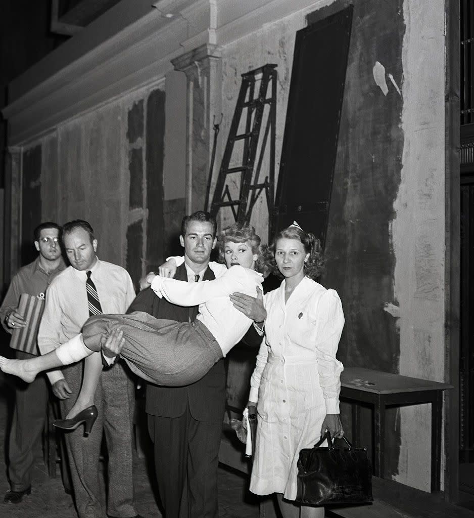 <p>While filming a scene for <em>Dark Corners</em>, Lucille tripped and fell from the stage. After injuring herself, she was carried off of the set by her costar Mark Stevens, while a doctor and nurse look on. </p>