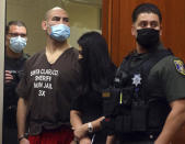 Former UFC heavyweight champion Cain Velasquez, second from left, with his attorney Alexandra Kazarian, makes an initial court appearance at the Santa Clara County Hall of Justice on Wednesday, March 2, 2022, in San Jose, Calif. Velasquez was arrested Monday on suspicion of attempted murder after he allegedly shot a man in Northern California, police said. (Aric Crabb/Bay Area News Group via AP, Pool)