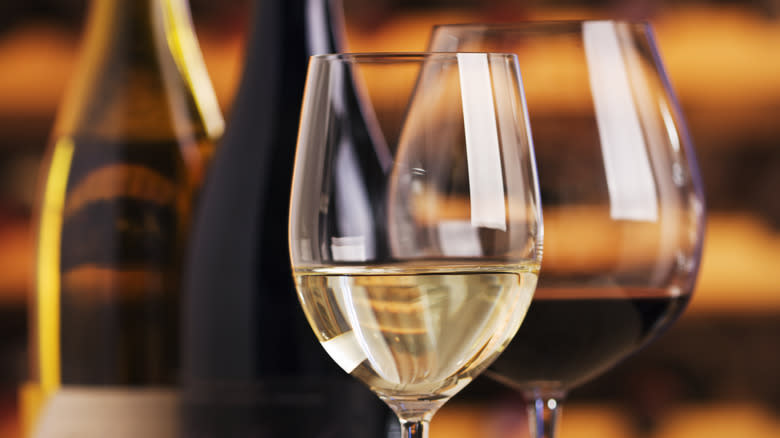 Close-up of a glass of white wine in front of a glass of red wine