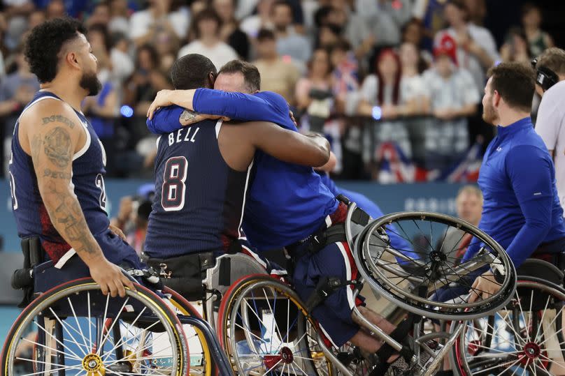 Steve Serio of the United States hugs teammate Brian Bell as they celebrate their victory in the wheelchair basketball gold medal match, Paris