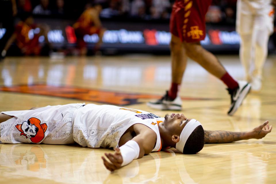 Oklahoma State's Avery Anderson III (0) lays on the floor during the first half of the NCAA college basketball game against Iowa State in Stillwater, Okla., Saturday, Jan. 21, 2023. (AP Photo/Mitch Alcala)