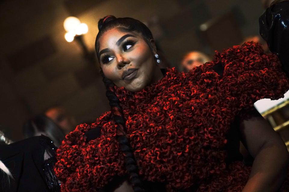 Rapper Lil' Kim listens during an interview before the Christian Siriano fashion show, during Fashion Week, Tuesday, Sept. 7, 2021, in New York.