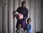 Prudence Aimee, 30, from Cameroon poses for a photo with her children from left to right Ange, Wifrid,1, and William, 3, pose for a portrait aboard the humanitarian rescue ship Ocean Viking, in Italian waters off the Sicilian town of Messina, southern Italy, Monday, Sept. 23, 2019, hours before disembarking. Prudence gave birth to her third son Sept. 13, just three days before boarding an overcrowded wooden boat in the hope of getting her children out of war-torn Libya. Her husband was not able to join them and stayed behind. Her eldest son William was very excited to arrive in Italy and waved at every boat that passed by while saying “Hey! Hey! Hey!” (AP Photo/Renata Brito)