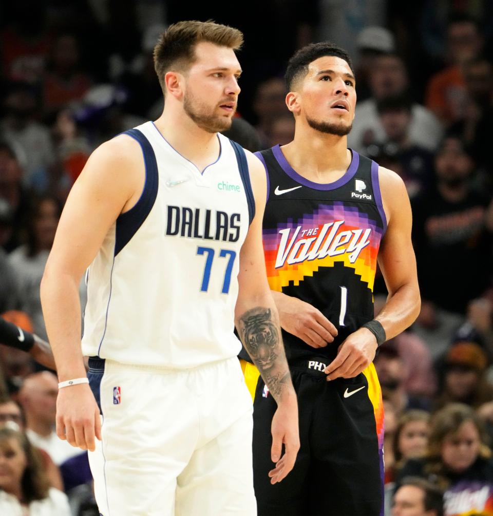 May 15, 2022; Phoenix, Arizona, USA; Dallas Mavericks guard Luka Doncic (77) and Phoenix Suns guard Devin Booker (1) react during game seven of the second round for the 2022 NBA playoffs at Footprint Center.