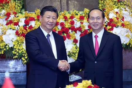 FILE PHOTO: Chinese President Xi Jinping (L) shakes hands with Vietnamese President Tran Dai Quang (R) at the Presidential Palace in Hanoi, Vietnam November 13, 2017. REUTERS/Luong Thai Linh/Pool/Fuile Photo