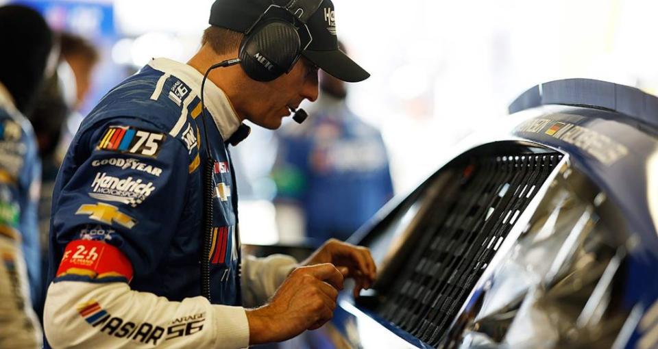 Garage 56 crew chief Greg Ives, by the window net of the No. 24 Chevrolet Camaro ZL1 in the Le Mans paddock.