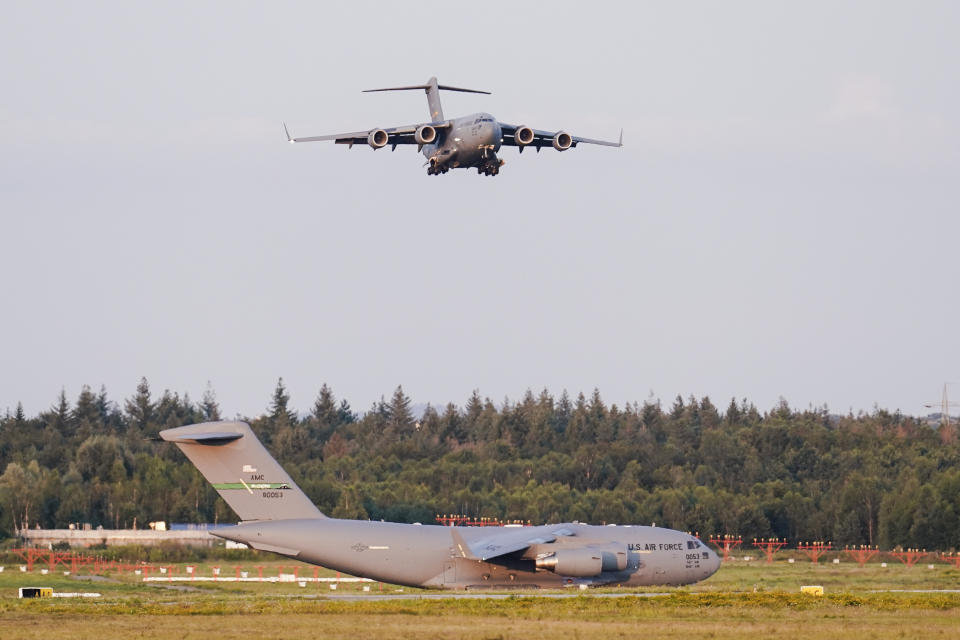 A transport plane carrying people flown out of Afghanistan lands at Ramstein Air Base, in Ramstein-Miesenbach, Germany. (Uwe Anspach/dpa via AP)