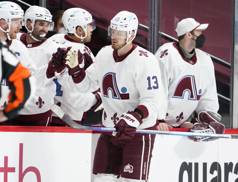 Colorado Avalanche right wing Valeri Nichushkin, front, is congratulated as he passes the team box after scoring a goal against the Anaheim Ducks in the second period of an NHL hockey game Friday, March 5, 2021, in Denver. (AP Photo/David Zalubowski)