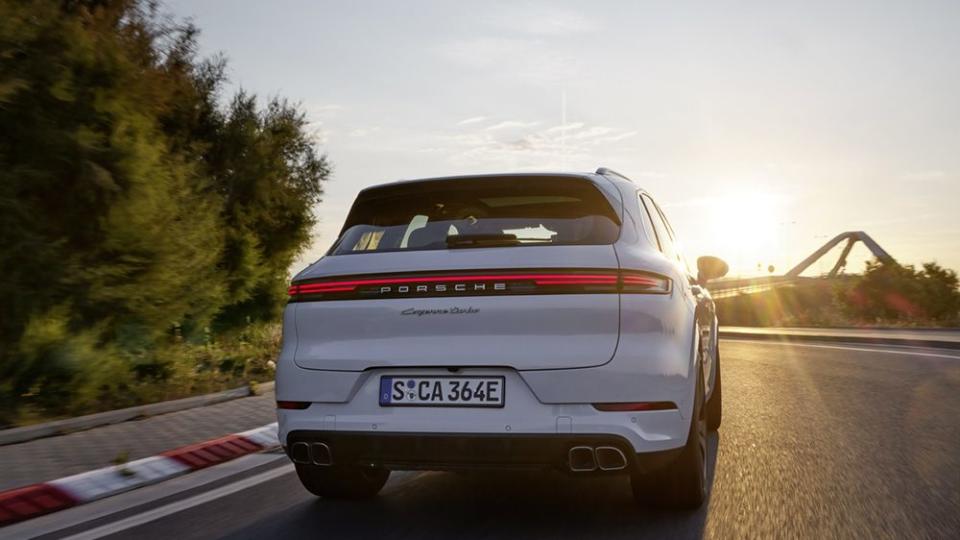 2024 porsche cayenne turbo ehybrid driving into the sunset