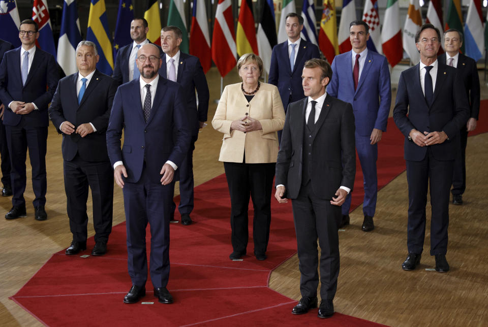 From front left, Poland's Prime Minister Mateusz Morawiecki, Hungary's Prime Minister Viktor Orban, Malta's Prime Minister Robert Abela, European Council President Charles Michel, Czech Republic's Prime Minister Andrej Babis, German Chancellor Angela Merkel, Belgium's Prime Minister Alexander De Croo, French President Emmanuel Macron, Spain's Prime Minister Pedro Sanchez, Dutch Prime Minister Mark Rutte and Italy's Prime Minister Mario Draghi pose during a group photo at an EU summit in Brussels, Thursday, Oct. 21, 2021. (AP Photo/Olivier Matthys)