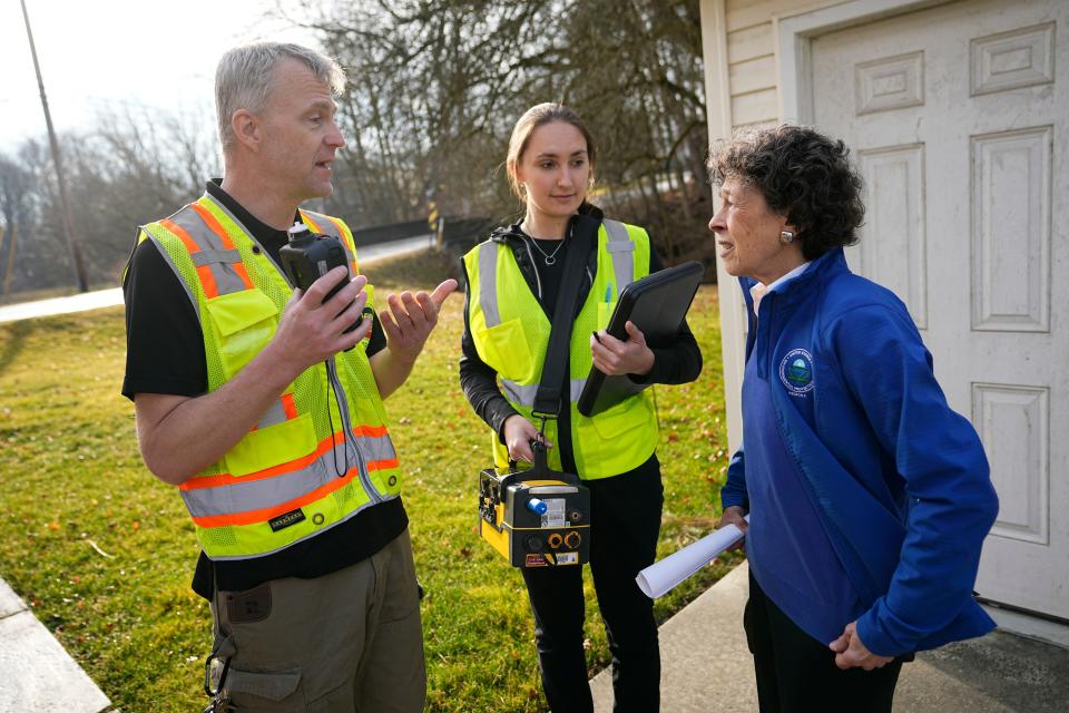 Feb 21, 2023; East Palestine, Ohio, USA;  EPA Region 5 Administrator Debra Shore talks to EPA on-scene coordinator James Justice and environmental scientist Natalia Smerage outside a home in East Palestine. Work continues to clean up the vinyl chloride chemical spill from the Norfolk Southern train derailment on Feb. 3. Mandatory Credit: Adam Cairns-The Columbus Dispatch