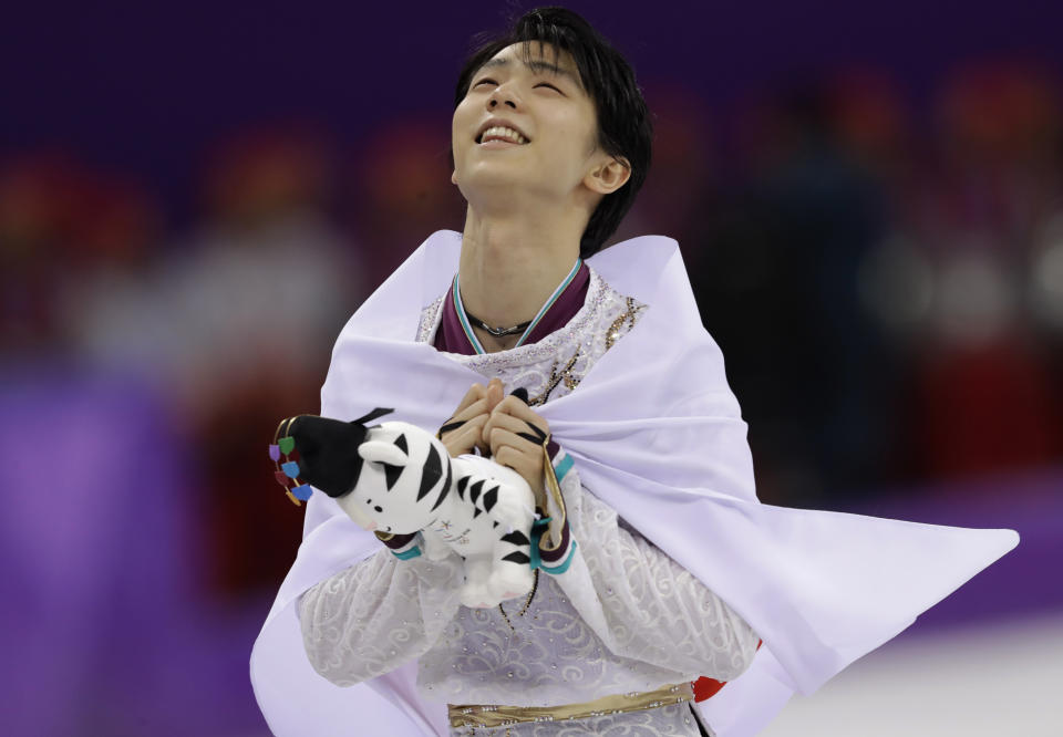 FILE - Yuzuru Hanyu, of Japan, celebrates after winning the gold medal in the men's free figure skating final in the Gangneung Ice Arena at the 2018 Winter Olympics in Gangneung, South Korea, on Feb. 17, 2018. Japan’s two-time Olympic gold-medal figure skater is expected to step away from competitive figure skating. Hanyu is expected to confirm his plans late on Tuesday, July 19, 2022, at a press conference in Tokyo. (AP Photo/Bernat Armangue, File)