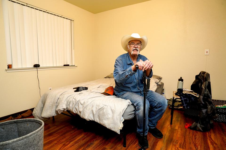 Jim Box of Redding sits on his bed in his Lauren Glen apartment on Dec. 8, 2023. The 64-year-old lived in inexpensive Redding hotels for 18 months while on a waiting list for a low-income apartment.