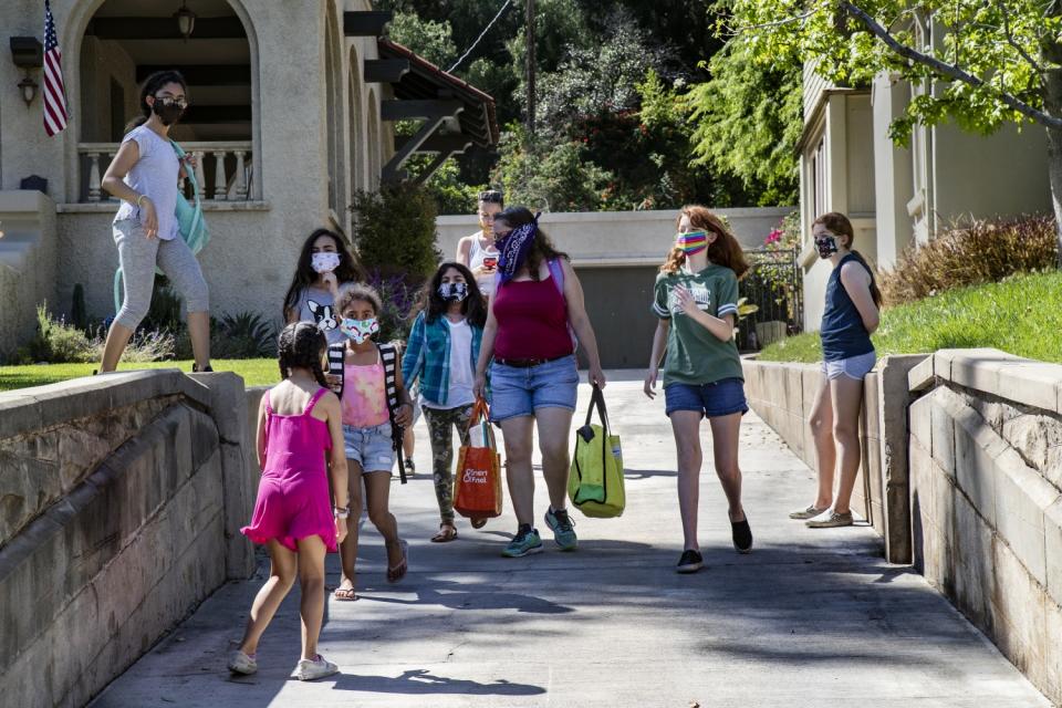 Students and parents of "Brothbush Academy" walk from the Bristows' house to the Furbushes' for a cooking class.