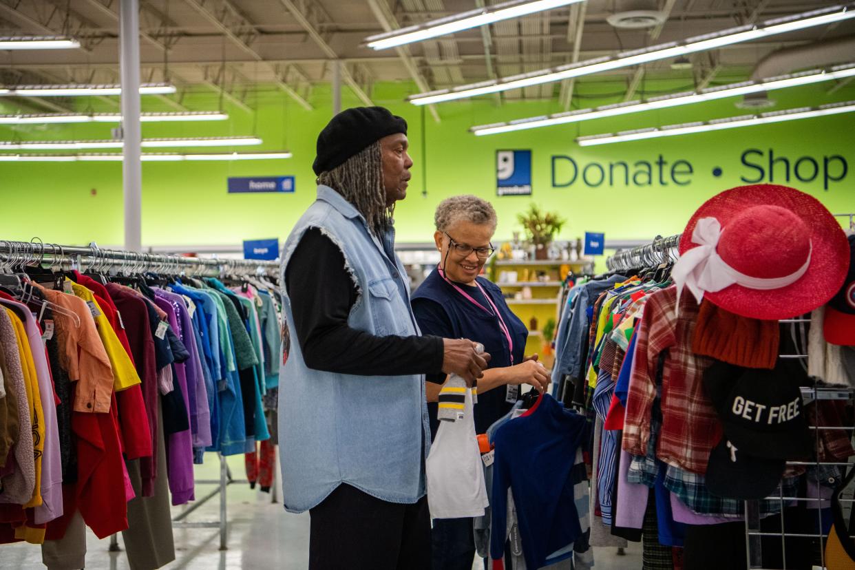 Jonathan Kelsey helps Missy Mayes pick out the orange tags clothes from the racks while working at Goodwill in Nashville, Tenn., Wednesday, April 3, 2024.