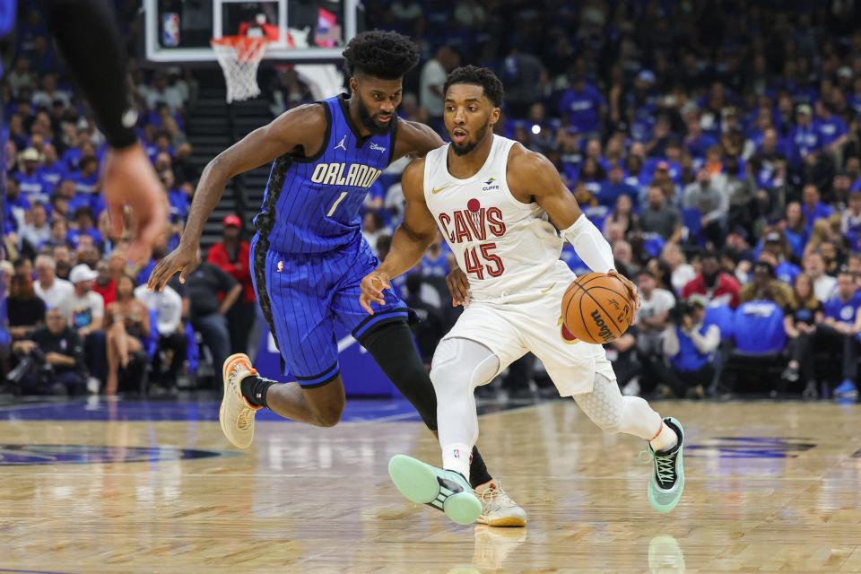 Cavaliers guard Donovan Mitchell drives to the basket against Magic forward Jonathan Isaac during the first quarter of Game 6 of a first-round playoff series, May 3, 2024, in Orlando.