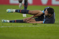 Marseille's Amine Harit lies on the pitch in pain during the French League One soccer match between Monaco and Marseille at the Stade Louis II in Monaco, Sunday, Nov. 13, 2022. (AP Photo/Daniel Cole)