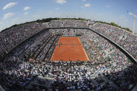 FILE - This May 27, 2015, file photo shows the center court at Roland Garros stadium, in Paris, France, as France's Gael Monfils plays his second round match against Argentina's Diego Schwarztman during the French Open tennis tournament. (AP Photo/David Vincent, File)