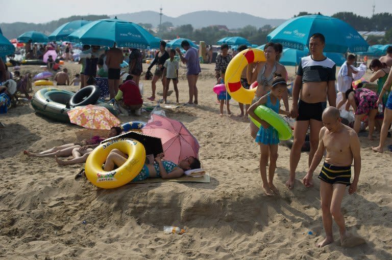 Holiday-makers at the seaside town of Beidaihe, east of Beijing, last summer. International tourist arrivals surpassed one billion for the first time last year, with the Asia-Pacific region posting the biggest increase in foreign visitors, and numbers will rise further in 2013, a UN body said Tuesday