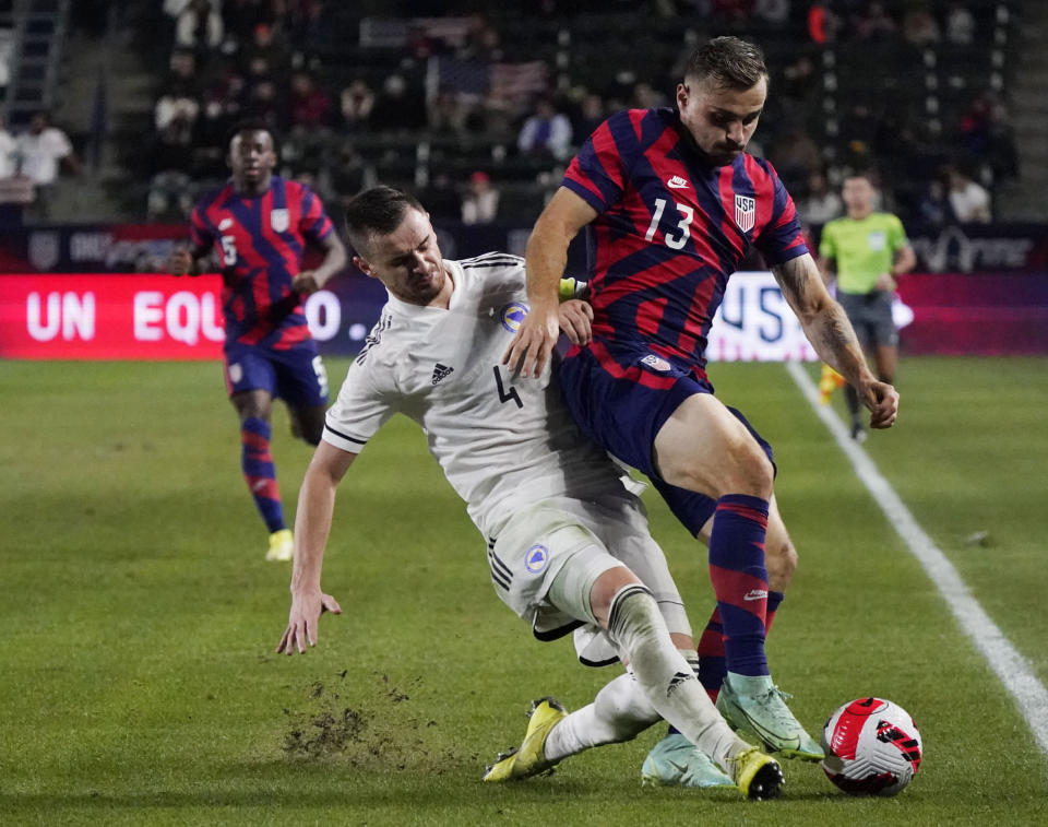 FILE - Bosnia and Herzegovina defender Ajdin Nukic, left, defends against United States forward Jordan Morris, right, during the second half of an international friendly soccer match Dec. 18, 2021, in Carson, Calif. Morris, Tim Weah, Sergiño Dest and Gyasi Zardes returned from injuries to make the U.S. roster ahead of the next three World Cup qualifiers. (AP Photo/Marcio Jose Sanchez, File)