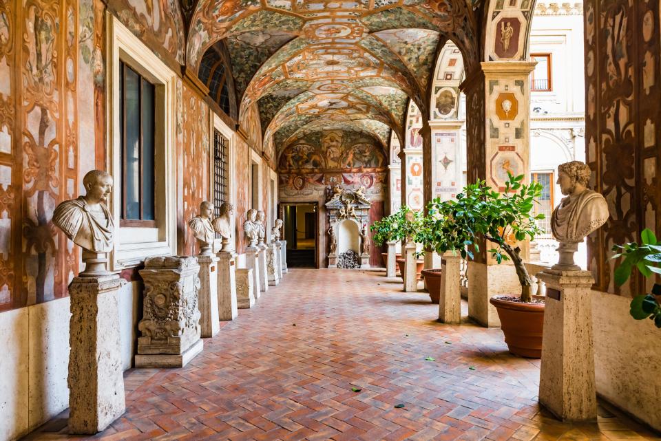 Palazzo Altemps with grand ceilings and sculptures lining hallway