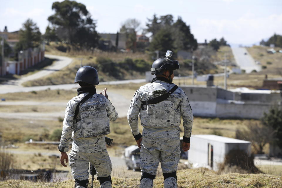 Mexican National Guard stand guard outside the Almoloya prison where Ovidio Guzman, the son of imprisoned drug lord Joaquin “El Chapo” Guzman, is being held in Villa de Almoloya de Juarez, Mexico, Friday, Jan. 6, 2023. (AP Photo/Ginnette Riquelme)