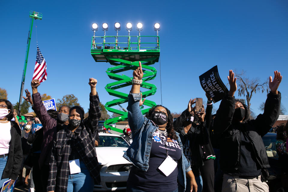 Supporters cheer for Vice President-elect Kamala Harris as she speaks during a drive-in rally in Columbus, Georgia. (Photo by Jessica McGowan/Getty Images)